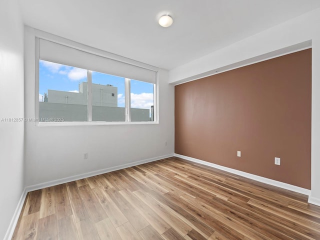 253 NE 2nd St Unit 3108, Miami, FL 33132 - empty room with wood finished floors and baseboards