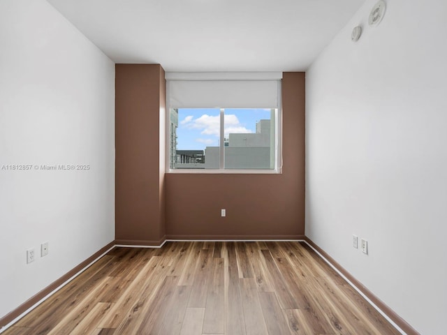 253 NE 2nd St Unit 3108, Miami, FL 33132 - spare room featuring light wood finished floors and baseboards