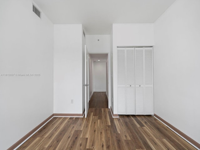 253 NE 2nd St Unit 3108, Miami, FL 33132 - unfurnished bedroom featuring dark wood finished floors, a closet, and baseboards