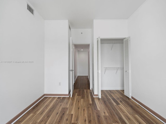 253 NE 2nd St Unit 3108, Miami, FL 33132 - unfurnished bedroom featuring a closet, wood finished floors, and baseboards