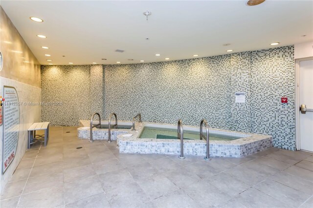 253 NE 2nd St Unit 3108, Miami, FL 33132 - bathroom with a bath, tile patterned flooring, tile walls, a sink, and recessed lighting