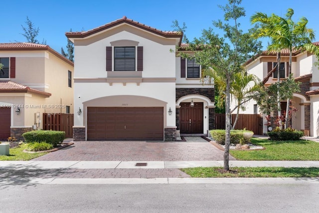 10023 NW 89th Ter, Doral, FL 33178 - view of front of house featuring stone siding, stucco siding, a garage, decorative driveway, and a tiled roof