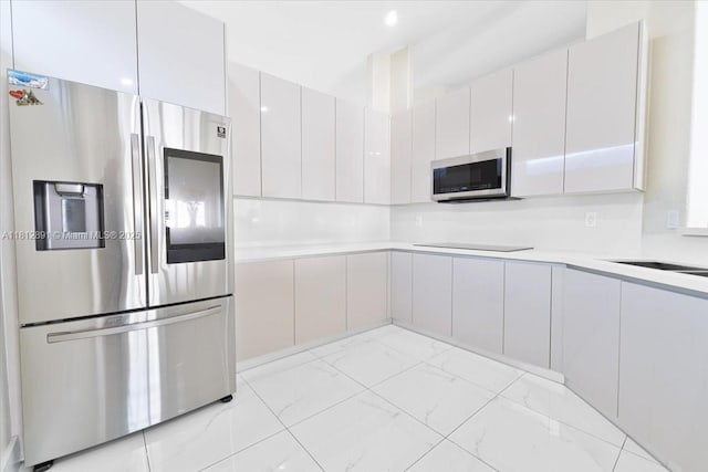8902 NW 148th St, Miami Lakes, FL 33018 - kitchen with stainless steel appliances, light countertops, modern cabinets, and light marble finish flooring