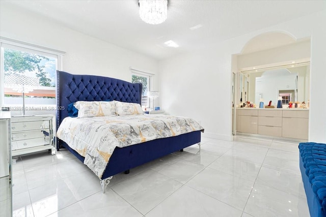 8902 NW 148th St, Miami Lakes, FL 33018 - bedroom with multiple windows, light marble finish flooring, and ensuite bath