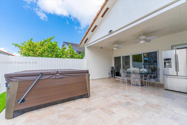 8902 NW 148th St, Miami Lakes, FL 33018 - fenced backyard with a hot tub, a ceiling fan, a patio, and outdoor dining space