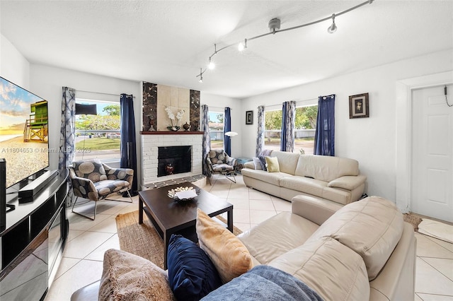 504 SW 5th Ave, Hallandale Beach, FL 33009 - living room with light tile patterned flooring, plenty of natural light, rail lighting, and a fireplace