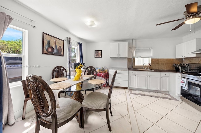 504 SW 5th Ave, Hallandale Beach, FL 33009 - dining room featuring a ceiling fan, light tile patterned floors, and a textured ceiling