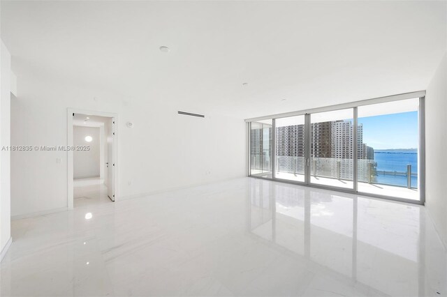300 Biscayne Boulevard Way Unit 1904C, Miami, FL 33131 - spare room with a wall of windows, a water view, and marble finish floors