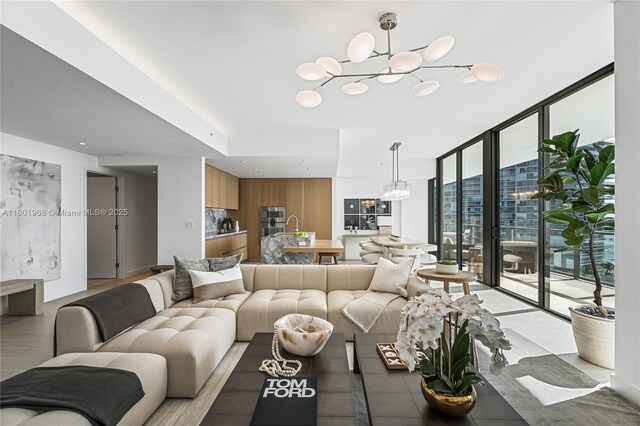 500 Alton Rd Unit 1603, Miami Beach, FL 33139 - living area featuring a chandelier and a wall of windows