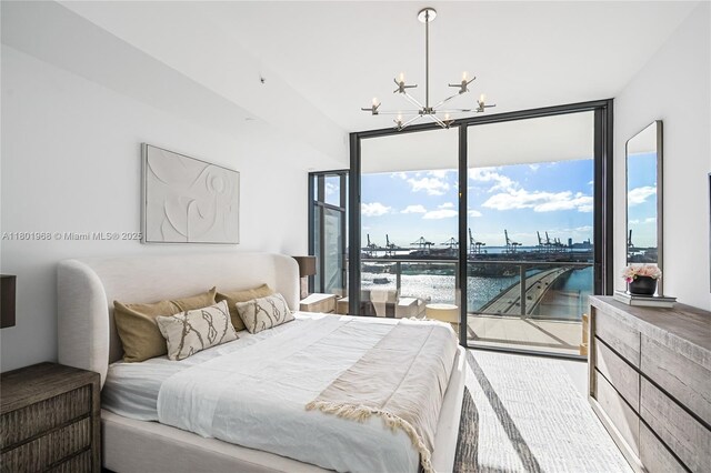 500 Alton Rd Unit 1603, Miami Beach, FL 33139 - bedroom featuring a chandelier, a water view, access to outside, and expansive windows