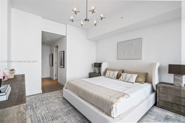 500 Alton Rd Unit 1603, Miami Beach, FL 33139 - bedroom featuring a chandelier, wood finished floors, and baseboards