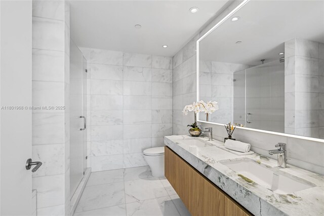 500 Alton Rd Unit 1603, Miami Beach, FL 33139 - bathroom with marble finish floors, a stall shower, double vanity, toilet, and recessed lighting