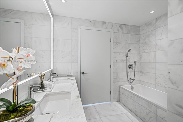 500 Alton Rd Unit 1603, Miami Beach, FL 33139 - bathroom featuring tile walls, double vanity, recessed lighting, tiled shower / bath, and marble look tiles