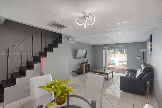 8022 SW 151st Ct Unit 603, Miami, FL 33193 - living room featuring stairs, light tile patterned floors, and baseboards