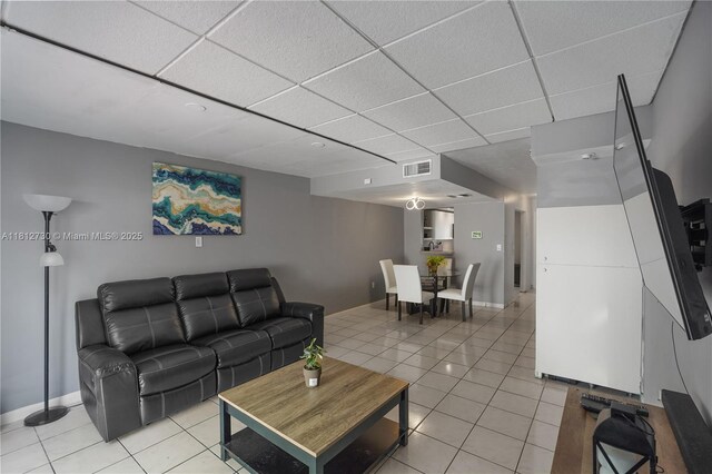 8022 SW 151st Ct Unit 603, Miami, FL 33193 - living area with light tile patterned flooring, a drop ceiling, and baseboards