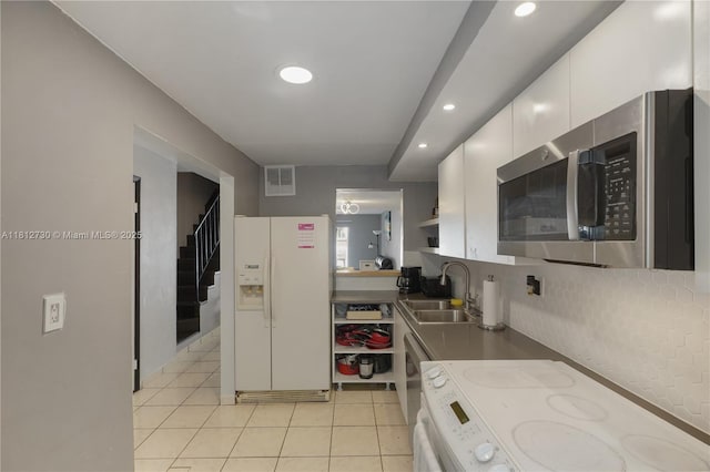 8022 SW 151st Ct Unit 603, Miami, FL 33193 - kitchen featuring white refrigerator with ice dispenser, stainless steel microwave, a sink, stove, and recessed lighting