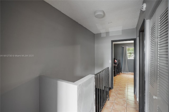 8022 SW 151st Ct Unit 603, Miami, FL 33193 - hall with an upstairs landing, light tile patterned flooring, and a textured ceiling