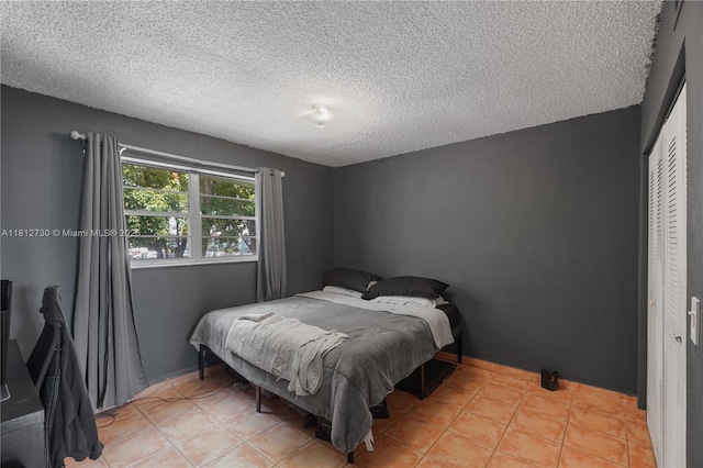 8022 SW 151st Ct Unit 603, Miami, FL 33193 - bedroom with a closet, a textured ceiling, and tile patterned flooring