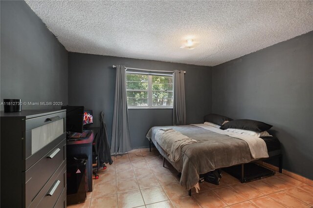 8022 SW 151st Ct Unit 603, Miami, FL 33193 - bedroom featuring a textured ceiling and light tile patterned floors