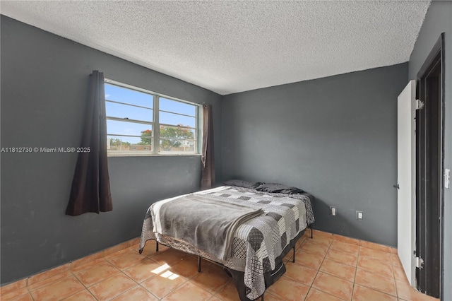 8022 SW 151st Ct Unit 603, Miami, FL 33193 - bedroom featuring a textured ceiling and tile patterned flooring