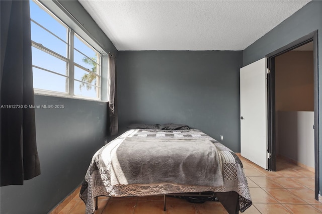8022 SW 151st Ct Unit 603, Miami, FL 33193 - tiled bedroom featuring a textured ceiling