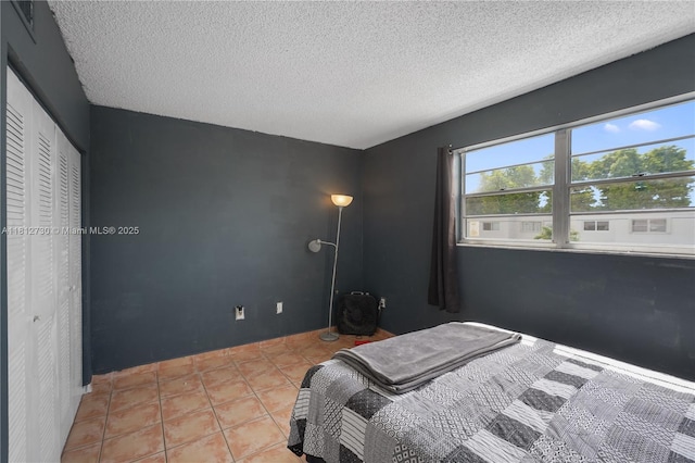 8022 SW 151st Ct Unit 603, Miami, FL 33193 - bedroom with a textured ceiling and light tile patterned flooring