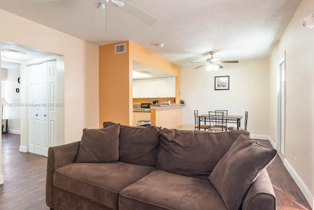 1321 Seaview, North Lauderdale, FL 33068 - living area with ceiling fan, a textured ceiling, dark wood-style flooring, and baseboards