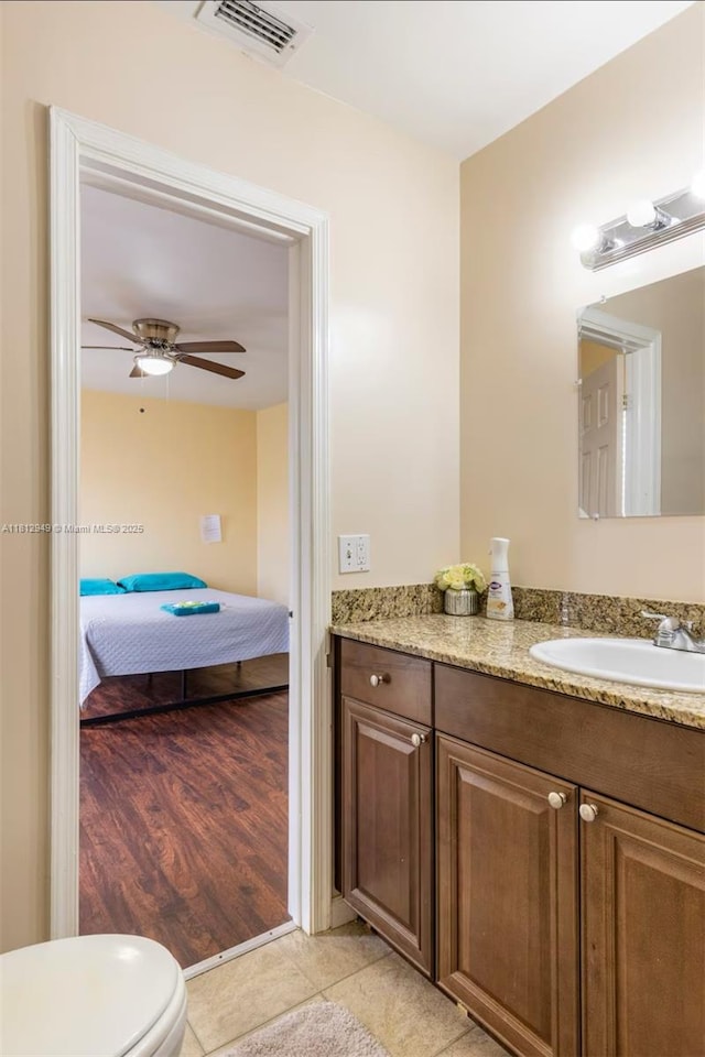 1321 Seaview, North Lauderdale, FL 33068 - ensuite bathroom featuring vanity, toilet, a ceiling fan, and wood finished floors