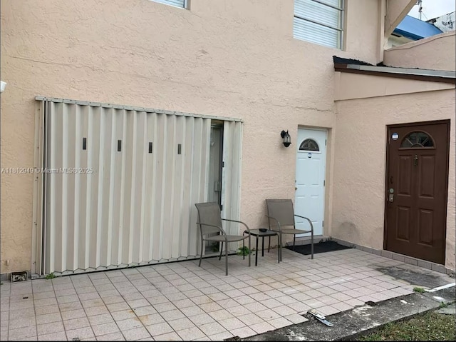 1321 Seaview, North Lauderdale, FL 33068 - property entrance with stucco siding and a patio area