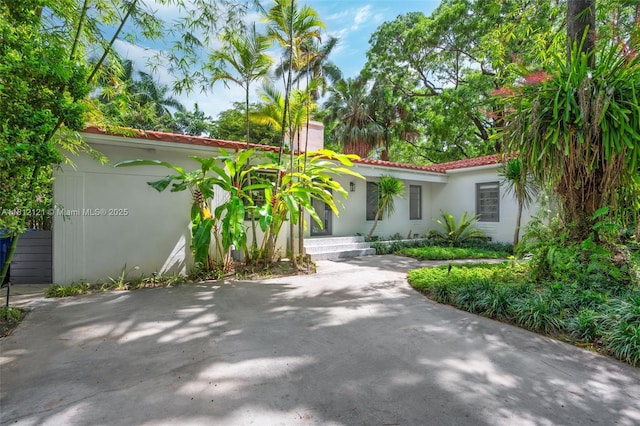 621 NE 55th St, Miami, FL 33137 - mediterranean / spanish house with stucco siding, a chimney, and a tiled roof