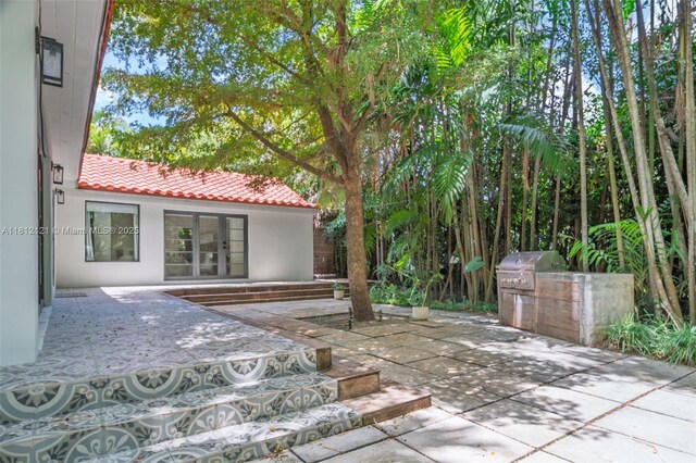 621 NE 55th St, Miami, FL 33137 - view of patio featuring area for grilling and french doors