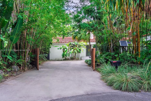 621 NE 55th St, Miami, FL 33137 - view of front of home featuring stucco siding, a tile roof, and a gate