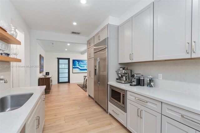 621 NE 55th St, Miami, FL 33137 - dining space with light wood-type flooring, a chandelier, crown molding, healthy amount of natural light, and baseboards