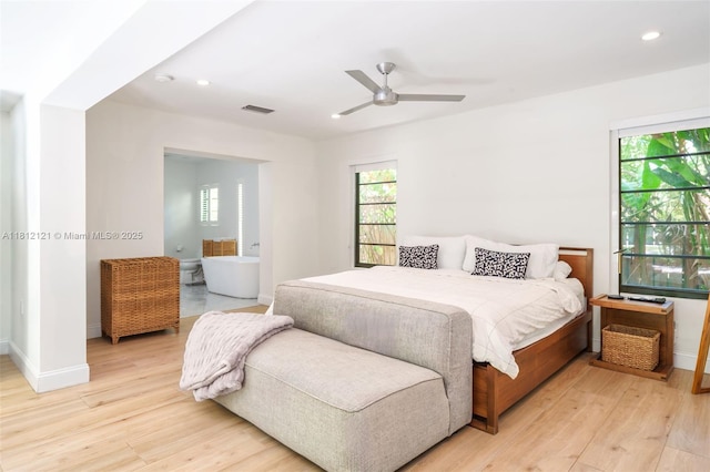 621 NE 55th St, Miami, FL 33137 - bedroom with light wood-type flooring, multiple windows, recessed lighting, and baseboards