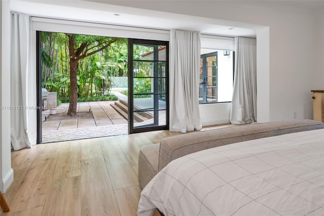 621 NE 55th St, Miami, FL 33137 - bedroom with access to exterior and wood finished floors