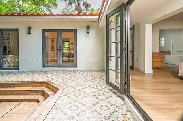 621 NE 55th St, Miami, FL 33137 - property entrance featuring french doors and stucco siding