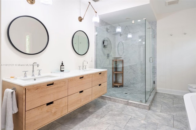621 NE 55th St, Miami, FL 33137 - full bath with double vanity, a stall shower, toilet, and baseboards