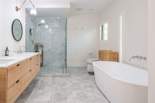621 NE 55th St, Miami, FL 33137 - bathroom featuring double vanity, a shower stall, a soaking tub, baseboards, and toilet