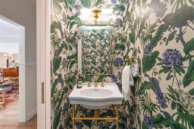 621 NE 55th St, Miami, FL 33137 - bathroom featuring wood finished floors, baseboards, and a sink