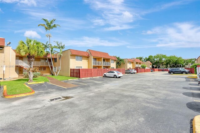 9972 SW 88th St Unit 1128, Miami, FL 33176 - uncovered parking lot featuring a residential view