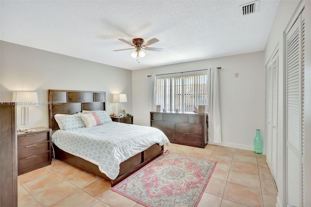 9972 SW 88th St Unit 1128, Miami, FL 33176 - bedroom with light tile patterned flooring, ceiling fan, and a textured ceiling