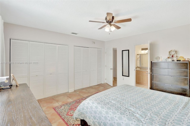 9972 SW 88th St Unit 1128, Miami, FL 33176 - bedroom with light tile patterned floors, two closets, ceiling fan, and ensuite bathroom