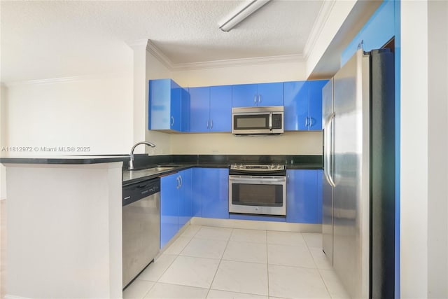 18800 NE 29th Ave Unit 1011, Aventura, FL 33180 - kitchen with stainless steel appliances, blue cabinetry, dark countertops, a sink, and crown molding