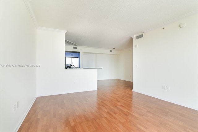18800 NE 29th Ave Unit 1011, Aventura, FL 33180 - spare room featuring ornamental molding, light wood-style floors, baseboards, and a textured ceiling