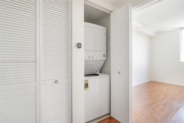 18800 NE 29th Ave Unit 1011, Aventura, FL 33180 - washroom featuring stacked washer / drying machine, light wood-type flooring, and baseboards