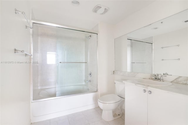 18800 NE 29th Ave Unit 1011, Aventura, FL 33180 - bathroom featuring toilet, vanity, enclosed tub / shower combo, and tile patterned flooring