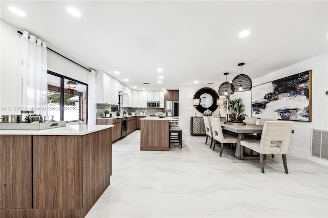 4029 NW 72nd Ave, Coral Springs, FL 33065 - kitchen with appliances with stainless steel finishes, recessed lighting, light countertops, backsplash, and a kitchen breakfast bar