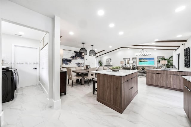 4029 NW 72nd Ave, Coral Springs, FL 33065 - kitchen with modern cabinets, independent washer and dryer, a center island, recessed lighting, and light countertops
