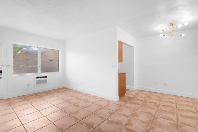 8040 Tatum Waterway Dr Unit 12, Miami Beach, FL 33141 - unfurnished room featuring a chandelier, light tile patterned flooring, a wall unit AC, and baseboards