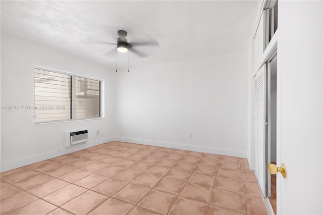 8040 Tatum Waterway Dr Unit 12, Miami Beach, FL 33141 - unfurnished room featuring ceiling fan, light tile patterned floors, baseboards, and an AC wall unit
